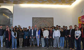 Eine Gruppe internationaler Studierender steht gemeinsam mit dem Oberbürgermeister und Vertretern der IHK, Hochschule, Universität und Stadt Trier im Foyer des Rathauses.